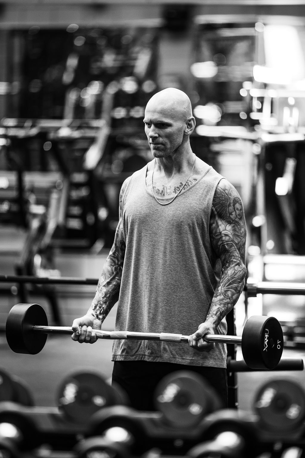 A member setting up for a barbell deadlift in front of the mirrored wall